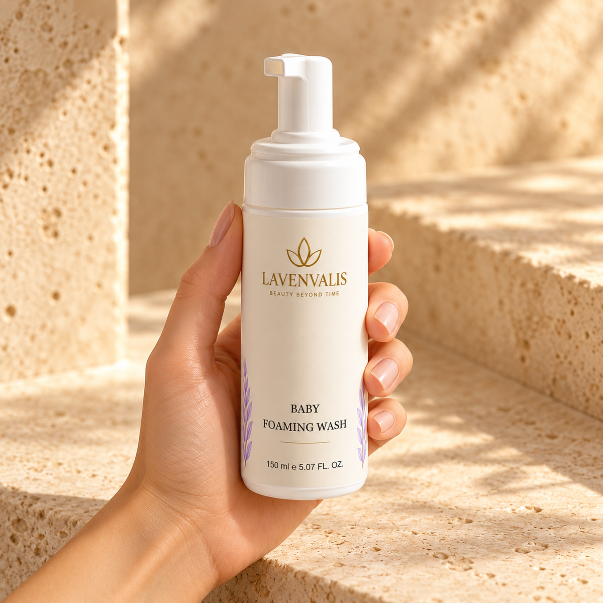 Lavenvalis Baby Foaming Wash 150 ml — bottle held by adult hand